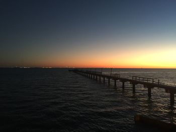 Scenic view of sea against clear sky during sunset