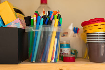 Colored markers in a plastic bucket