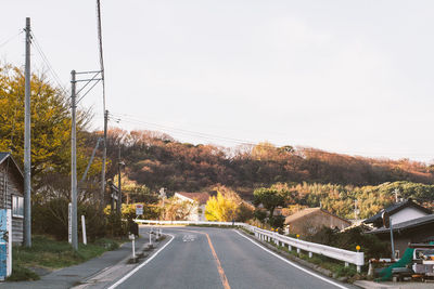 Empty road along trees