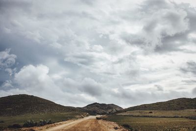 Scenic view of mountains against cloudy sky