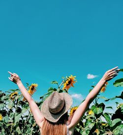 Rear view of woman against blue sky