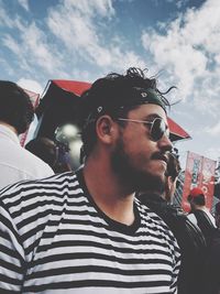 Portrait of young man wearing sunglasses against sky