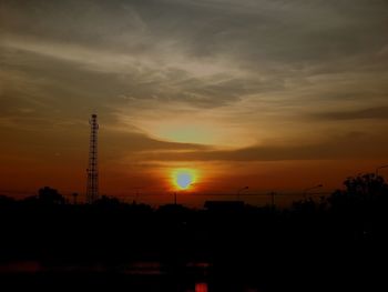 Silhouette of tower against sky during sunset
