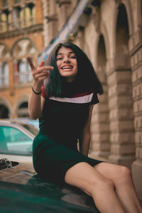 Young woman sitting outdoors