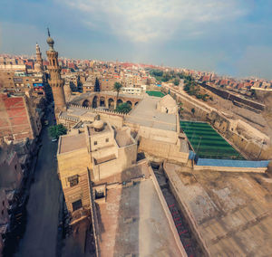 High angle view of city buildings against sky