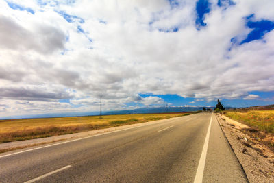 Empty road along countryside landscape