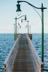 Pier over sea against sky