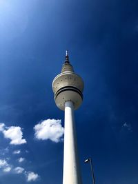 Low angle view of communications tower against sky