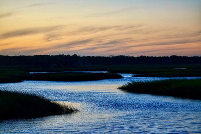 Scenic view of lake against sky during sunset