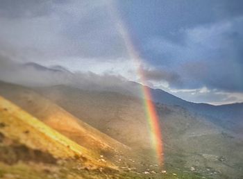 Rainbow over mountains against sky