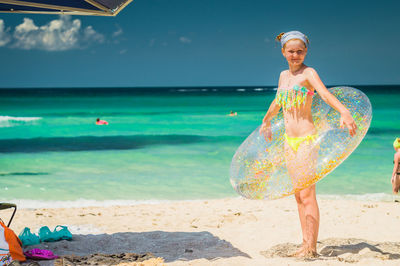 Girl with inflatable ring at beach 