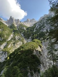 Low angle view of green mountains against sky
