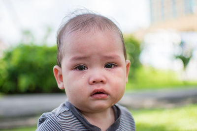 Close-up portrait of cute baby boy crying