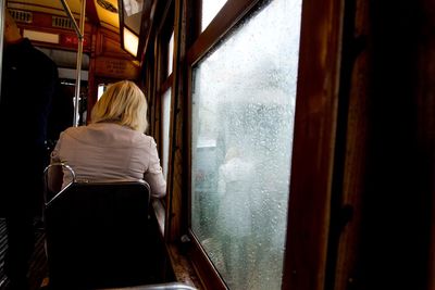 Rear view of woman sitting in train