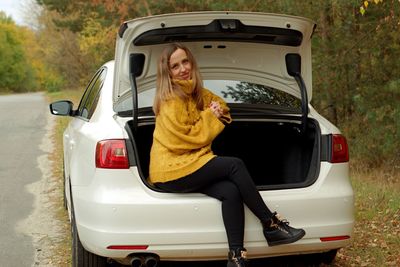 Portrait of young woman in car