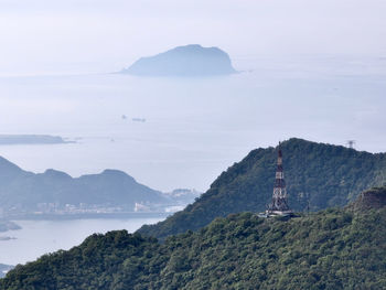 Scenic view of sea and mountains against sky