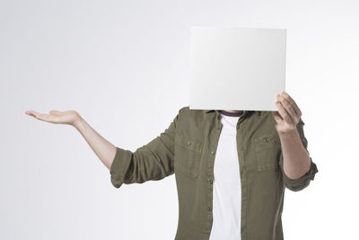 Low section of person standing on paper against white background
