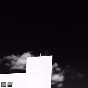 Low angle view of building against cloudy sky