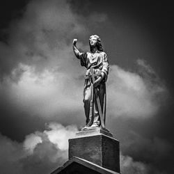 Low angle view of statue against cloudy sky