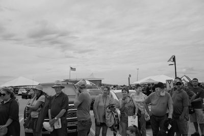 Crowd on street against sky