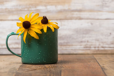 Close-up of yellow flower on table