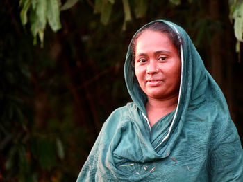 Portrait of young woman standing outdoors