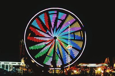 Low angle view of illuminated ferris wheel