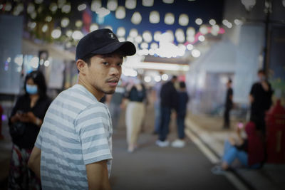 Man standing in illuminated city at night