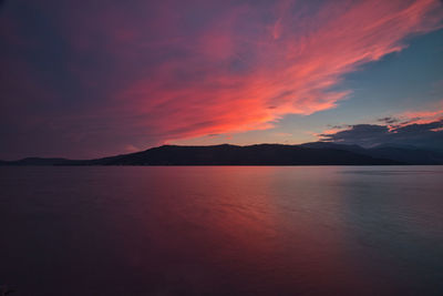 Scenic view of lake against romantic sky at sunset