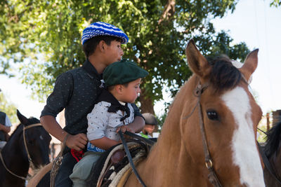 Little boys riding horse in south american traditional festival