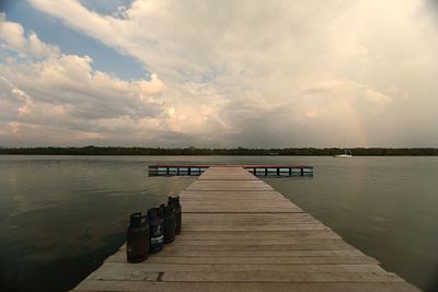 Pier over river against sky