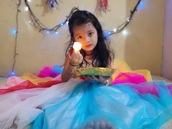 Portrait of young woman holding christmas tree