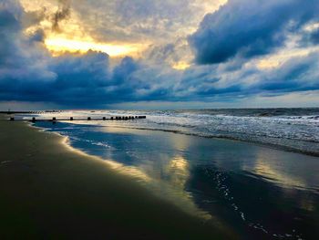 Scenic view of beach against sky during sunset
