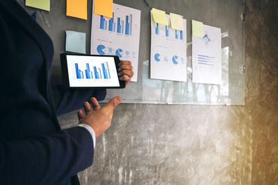 Midsection of businessman working in office