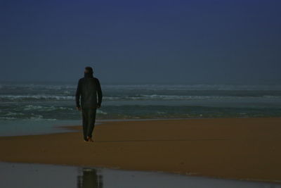 Silhouette of people standing on beach