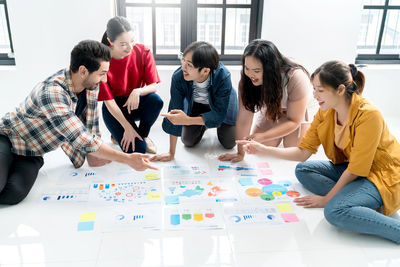 People discussing while sitting on floor