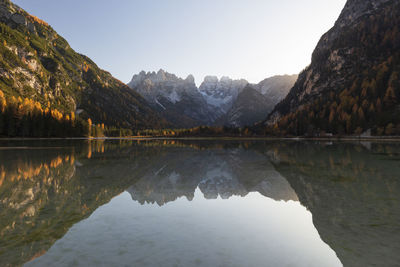 Scenic view of lake and mountains against clear sky