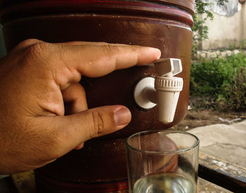 Close-up of hand holding coffee cup