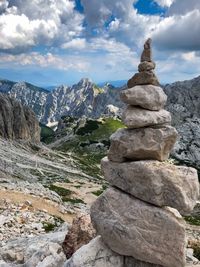 Stack of rocks on mountain against sky