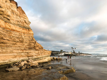 View of beach against cloudy sky