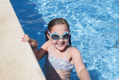 Portrait of woman swimming in pool