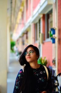 Young woman looking away while walking in lobby