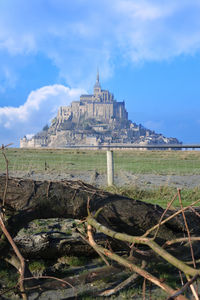 Mont saint michel view against blue sky and clouds.