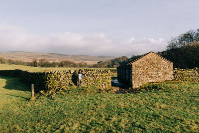 Built structure on field against sky