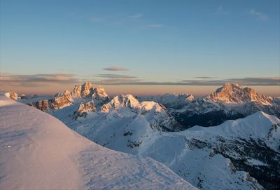 Scenic view of snowcapped mountains against sky during sunset