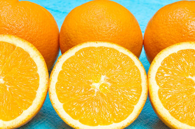 Close-up of orange fruits on blue table