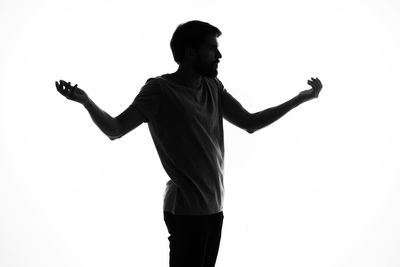 Low angle view of man standing against white background