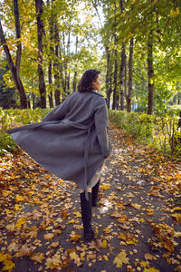 Rear view of woman walking in forest