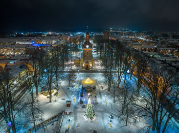 High angle view of illuminated buildings in city at night