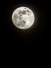 Low angle view of full moon at night